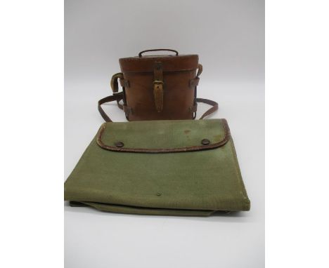 A pair of World War 1 field glasses with a leather case. Case is inscribed with broad arrow mark, Parisian &amp; Opera field 