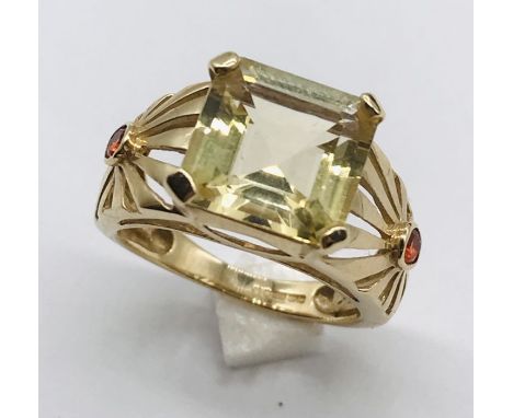 A 9ct gold citrine ring with pierced shoulders