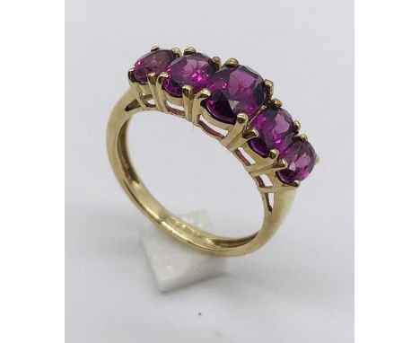 A garnet five stone ring set in 9ct gold