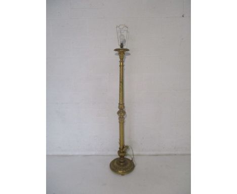A gilded standard lamp.