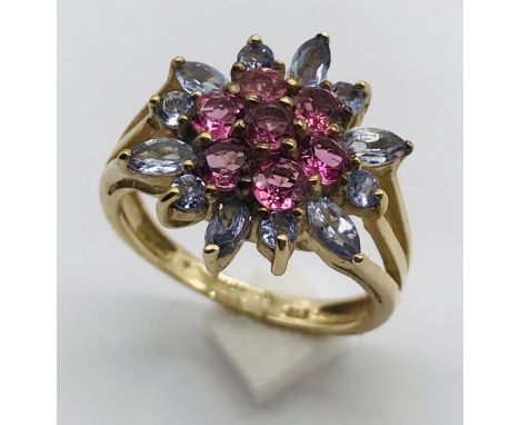 A garnet and amethyst cluster ring set in 9ct gold