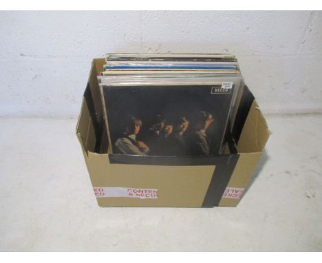 A quantity of 12" vinyl records, including The Rolling Stones, Buddy Holly, The Moody Blues, Monkees, Manfred Mann etc.