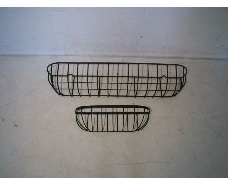 A large metal garden wall hanging planter frame, along with another smaller.