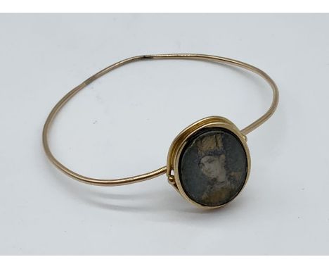 A 14ct gold (tested) bracelet with hand painted portrait of an Indian lady (Mogul), glass heavily scratched, total weight 9.7