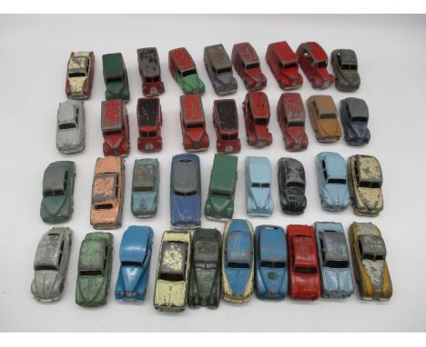 A collection of vintage Dinky play worn die-cast cars and vans including Ford Sedans, Trojan Vans, Morris Oxford, Royal Mail 