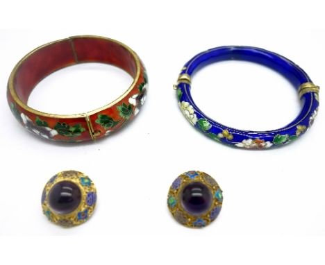 A pair of silver clip on earrings and two enamel bangles