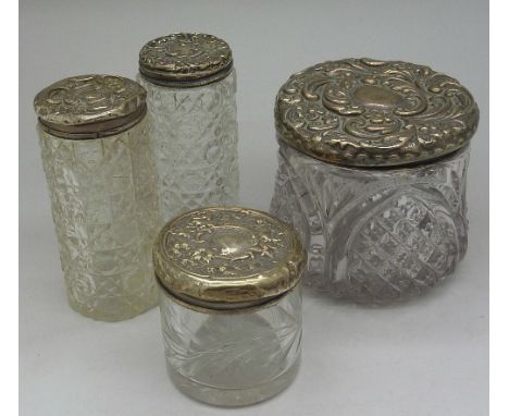 Four silver topped jars