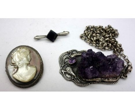 A silver and amethyst pendant and chain and two silver brooches