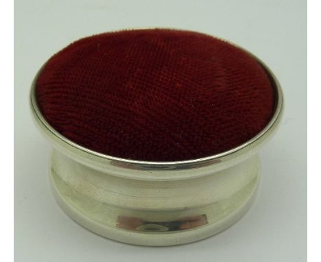 A modern silver pin cushion