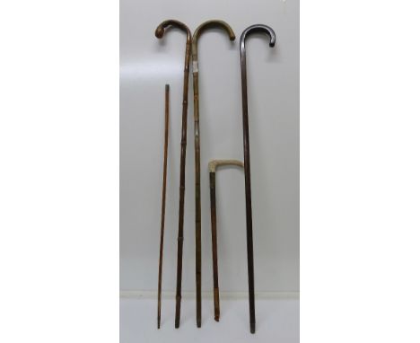 Three walking sticks, a riding crop and a swagger stick