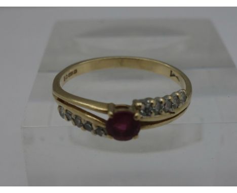 A 9ct gold, diamond and ruby ring, weight 1.5g, size M