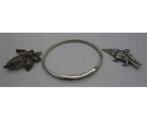 Two silver brooches and a silver bangle set with three diamonds