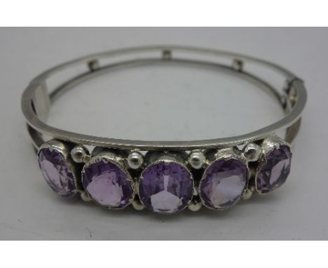 A silver and amethyst bangle
