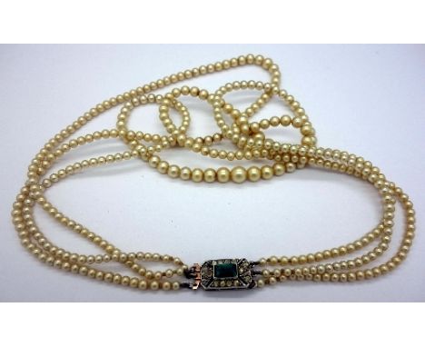 A three strand faux pearl necklace with silver Art Deco clasp