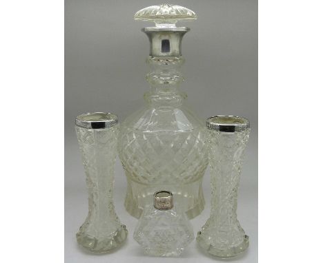 A pair of silver rimmed vases, a silver rimmed scent bottle and a silver topped glass decanter, scent lacking stopper