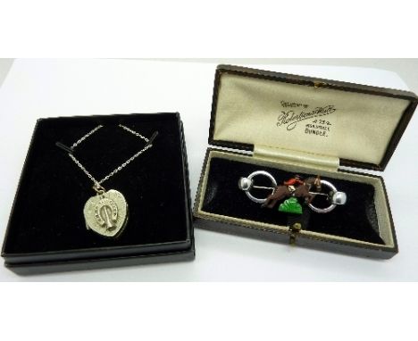 A Victorian silver horseshoe locket and chain and an Art Deco equestrian brooch