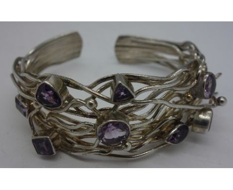 A white metal and amethyst bangle