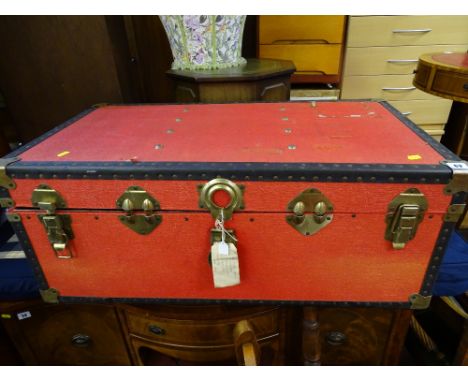 Red metal banded travel trunk