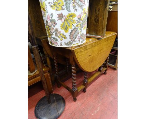 Oak drop leaf barley twist gate leg table and a turned column standard lamp with shade