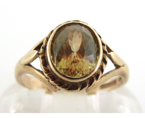 A 9 carat gold and zircon ring, the oval cut stone 7 x 6 x 4mm, the mount fully hallmarked, finger size H/I, 2gms CONDITION: 