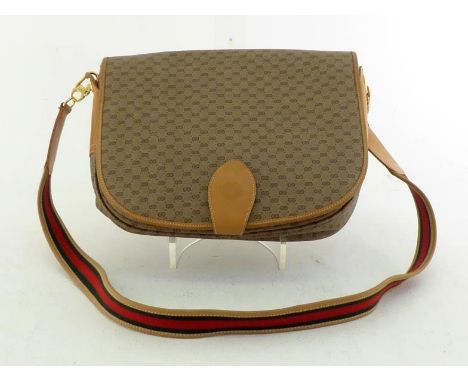 A Vintage Gucci monogrammed messenger bag with striped strap. Labelled inside Gucci Italy #14.001.4732. CONDITION: Good, clea