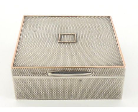 A silver engine-turned square cigarette box with gold edge to cover and gold frame centering cover, by Asprey & Co. Ltd., Che