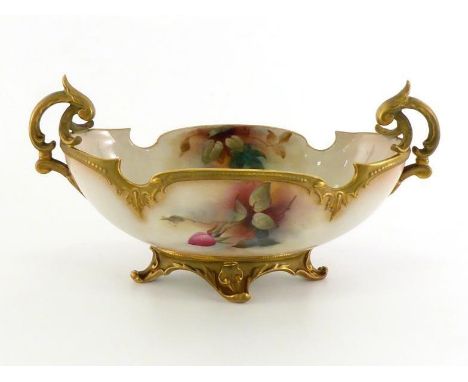 A Royal Worcester two handled oval bowl with shaped gilt rim on a deep gilt base with four scrolling feet, painted inside and