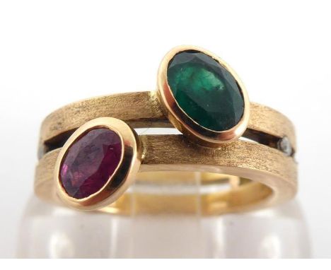 An 18 carat gold, ruby, emerald and diamond ring, rub over set to the front with an oval cut emerald and ruby, the larger eme