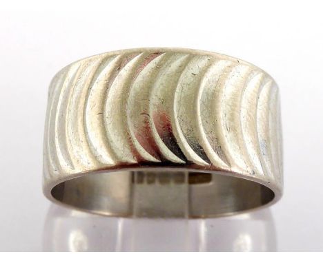 An 18 carat white gold band, fully hallmarked to the centre, finger size R, 8.9gms 