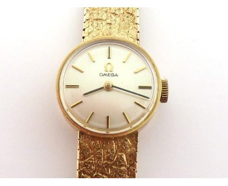 OMEGA, a lady's 9 carat gold manual wind wristwatch, the small silvered dial with baton detail, the 17 jewel OMEGA movement c