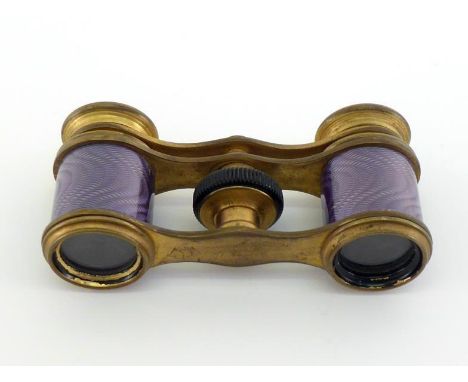 A pair of pocket size opera glasses in matt gilt brass, the body with engine-turned mauve enamel effect. In very good conditi