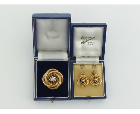 A mid Victorian gold, enamel and split pearl knot brooch, the central box with a star of blue enamel, a split pearl to the ce