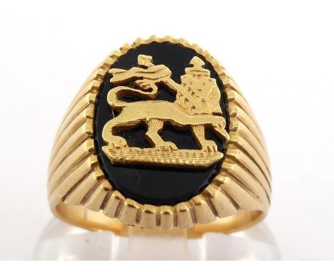 A yellow metal (tests 18 carat gold) and onyx signet ring, the onyx with applied gold Ethiopian Lion of Judah, finger size M,