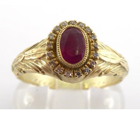 A 14 carat gold, ruby and diamond ring, the central oval cut ruby 6 x 4mm, in a surround of small brilliants, to chased acant