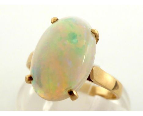 A 14 carat gold and opal ring, the oval cabochon 14 x 9mm, the shank import marked, finger size M, 3gms CONDITION: good play 