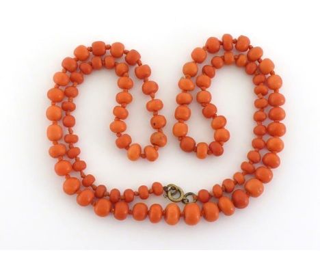 A coral bead necklace, composed of graduated 5.4-9.2mm circular beads, to a yellow metal bolt ring clasp, 64cm long, 34.1gms 
