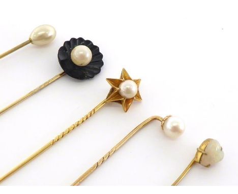 Four cultured pearl-set stick pins, including one mounted in an onyx shell, together with a small precious opal example (5) C