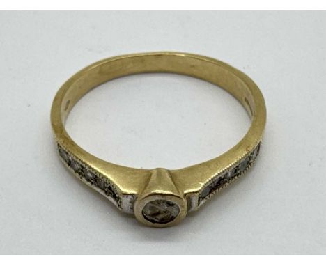 A 9ct Gold Diamond Inset Ring, circular rubover set to centre, between inset shoulders and uniform band (finger size Q) (2.4g