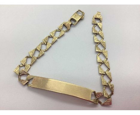 A Curb Link ID Bracelet, of partial bark textured design, with vacant rectangular panel to centre, stamped "375" "MG" to clas