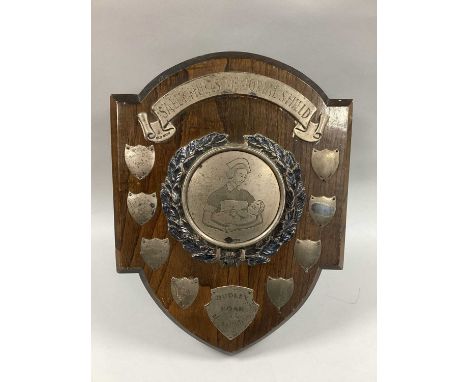 A Hallmarked Silver Mounted Presentation Shield, "Sally Hulls Memorial Shield" (scroll banner hallmarked Birmingham 1965), "D