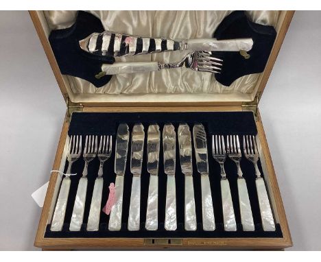 A Set of Six Mother of Pearl Handled Fish Cutlery, complete with fish servers, stamped "G&amp;Co EPNS A1", in a fitted wooden