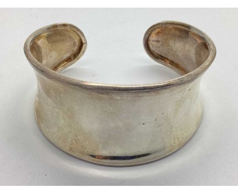 A Modern Wide Cuff Bangle, of plain tapered design, stamped "925 IBB".