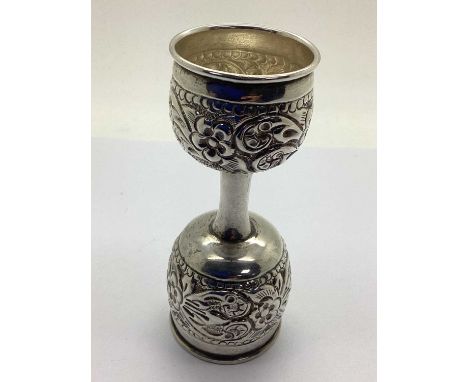 An Indian Style Double Ended Spirit Measure, of raised floral design, (unmarked), 10.3cm height (50grams).