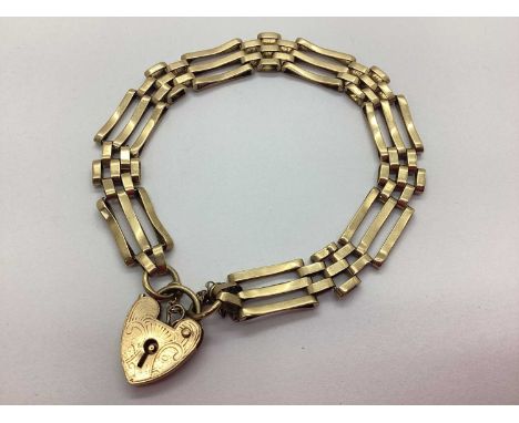 A 9ct Gold Gate Link Bracelet, to a decorative 9ct gold heartshape padlock clasp and safety chain approximately 18cm long (10