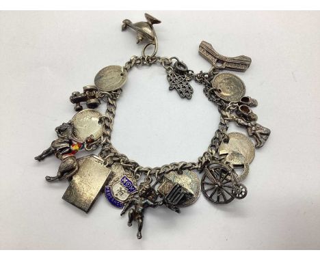 A Curb Link Charm Bracelet, suspending assorted charms, including 'Sterling Silver' St. Christopher, 'SIL' genie lamp, horseh