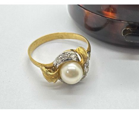 An Abstract Freshwater Pearl and Stone Set Dress Ring, the pearl bead set within crossover frame and foliage style shoulders,