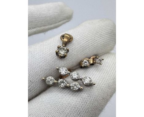 A Pair of 9ct Gold Three Stone Diamond Drop Earrings, the round brilliant cut diamonds illusion set to beaded spacers, approx