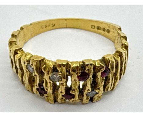 An 18ct Gold Diamond and Stone Set Dress Ring, of pierced abstract design and bark textured finish, between tapered shoulders