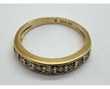 A Nine Stone Diamond Half Eternity Style Ring, inset to plain tapering band, stamped "14K" "MAC" "K" (finger size M) (2.6gram