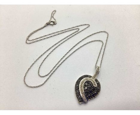 TGGC; A Modern 9ct White Gold Diamond Set Pendant, of abstract design, on fine link chain (clasp stamped "375").The chain is 